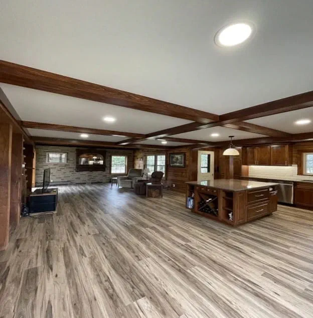 A remodeled kitchen with wood and tile flooring