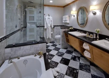Black and white marble floor tile in master bathroom