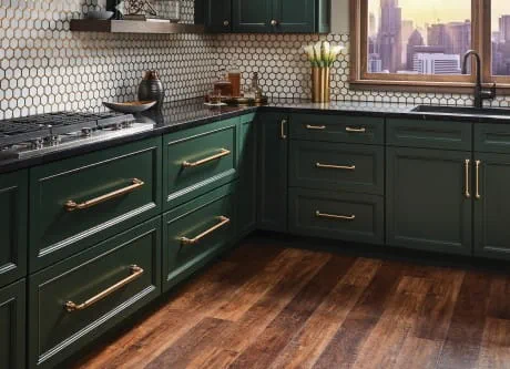 Green kitchen cabinets with gold pulls and knobs hardware