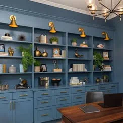 A remodeled home office with deep blue cabinets