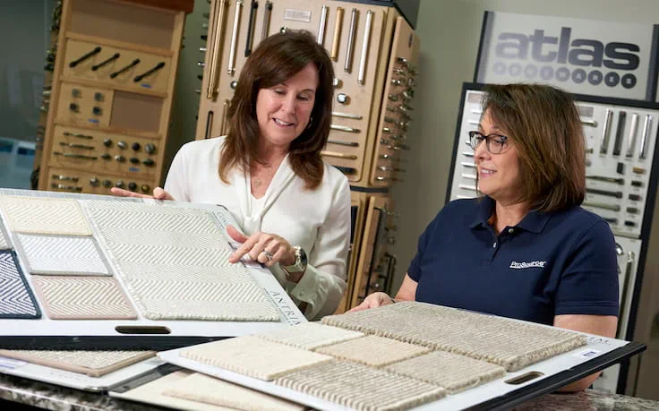 A ProSource account manager showing product samples to a homeowner