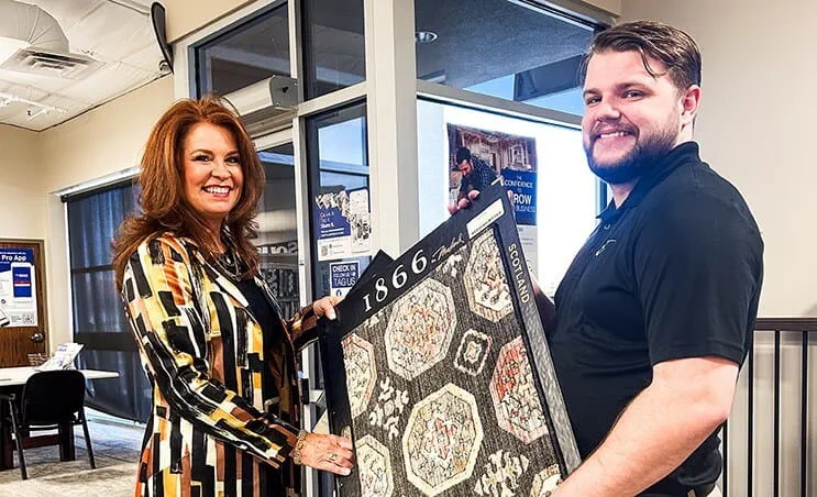 Designer and account manager holding a carpet sample