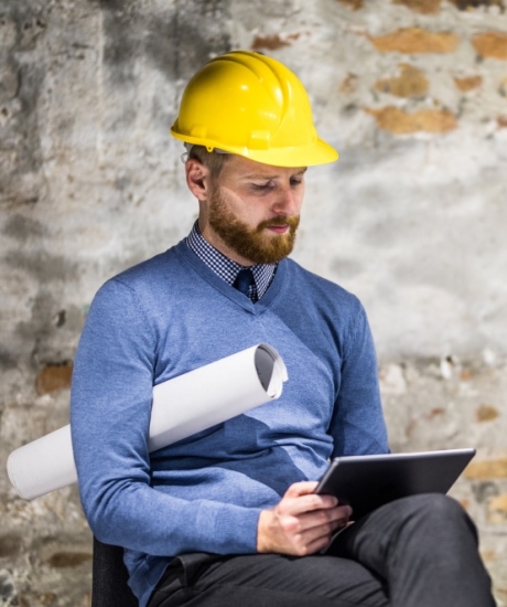 Builder reading a tablet about ProSource Wholesale