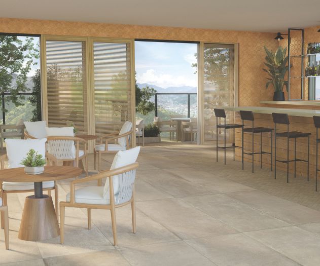Image of a bright café lounge with large windows, indoor and outdoor seating, modern furniture, and an inviting atmosphere.