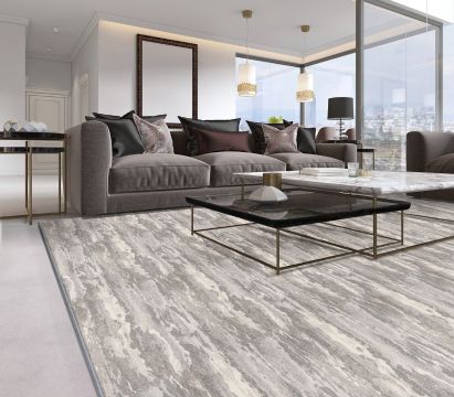 Modern living room with a large sofa, coffee table, and large windows.