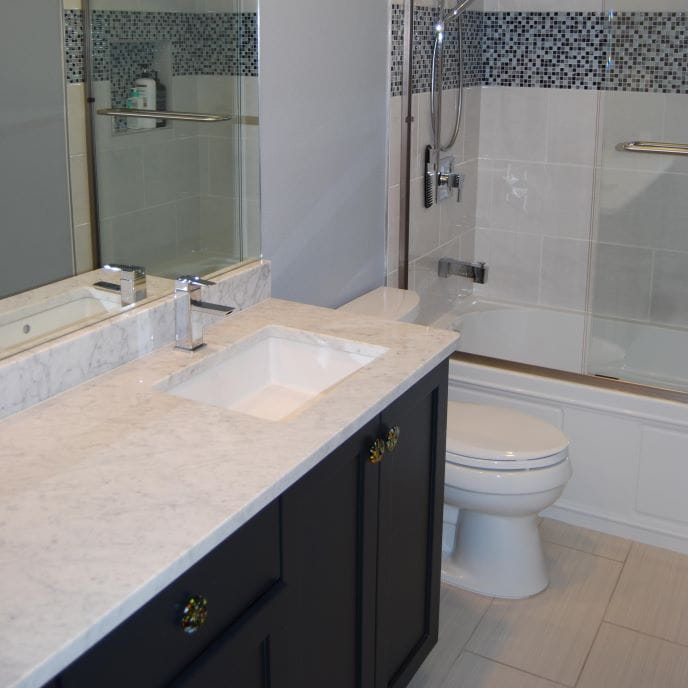 Custom small bathroom remodel with drop-in sinks and modern fixtures