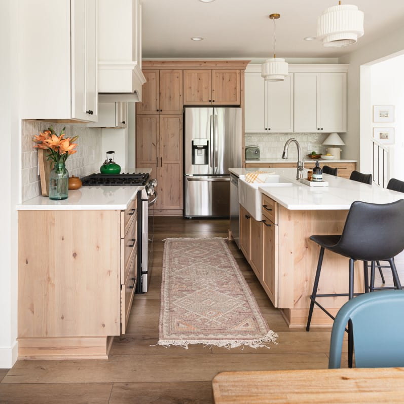 Light wood stained cabinets with white countertops in a remodeled kitchen