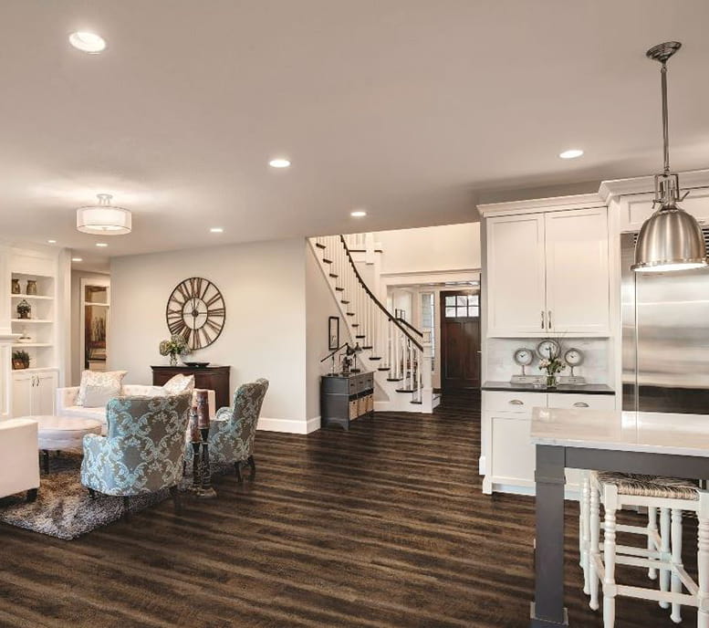 Transitional living and adjoining kitchen room with natural hardwood floors