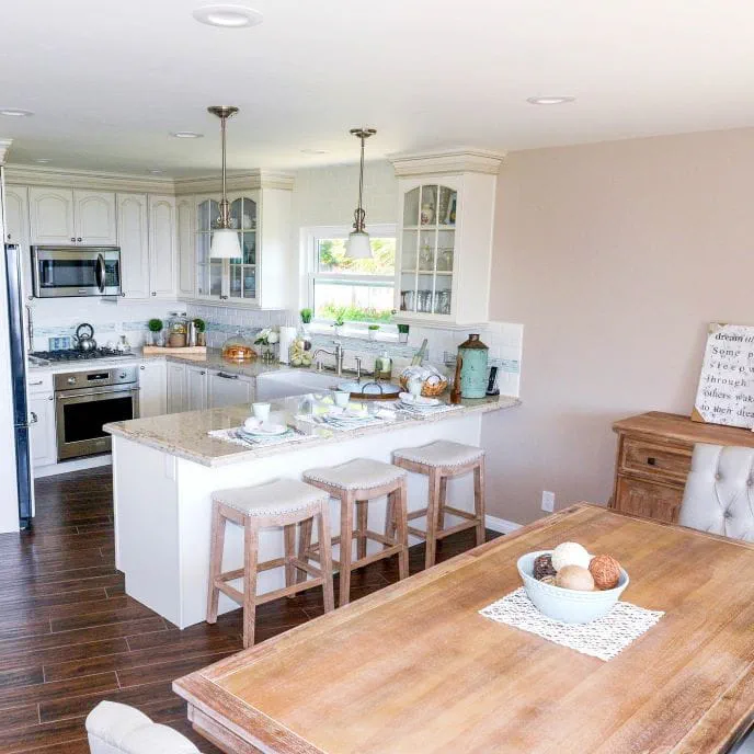 Chic farmhouse style kitchen with cream glass door cabinet fronts