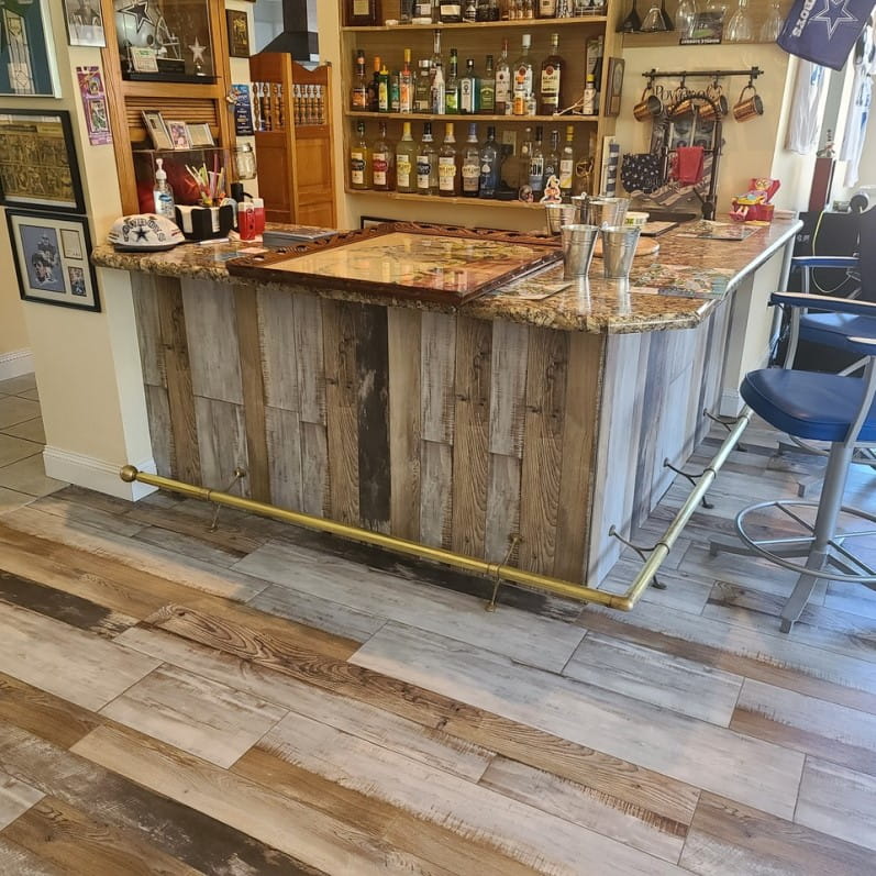 Luxury vinyl plank flooring near a home bar