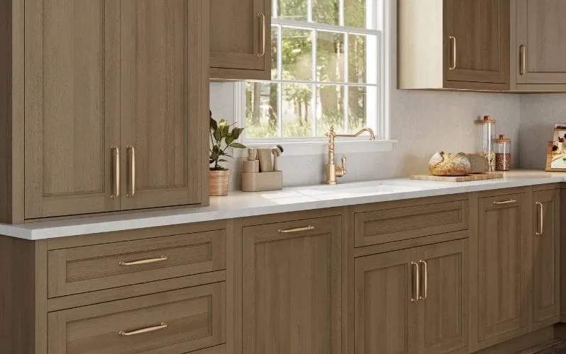 A kitchen interior with wooden cabinets, marble countertops, and a large window.