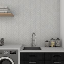 Gray chevron wall tiles in the laundry room