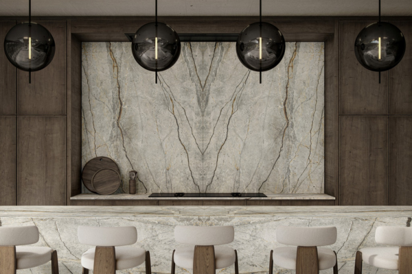 Modern kitchen with bookmatched quartz backsplash, island, and flooring, featuring neutral tones, sleek cabinetry, and contemporary bar stools.