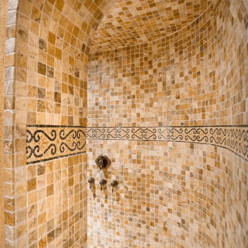 Tiled shower wall with decorative accents