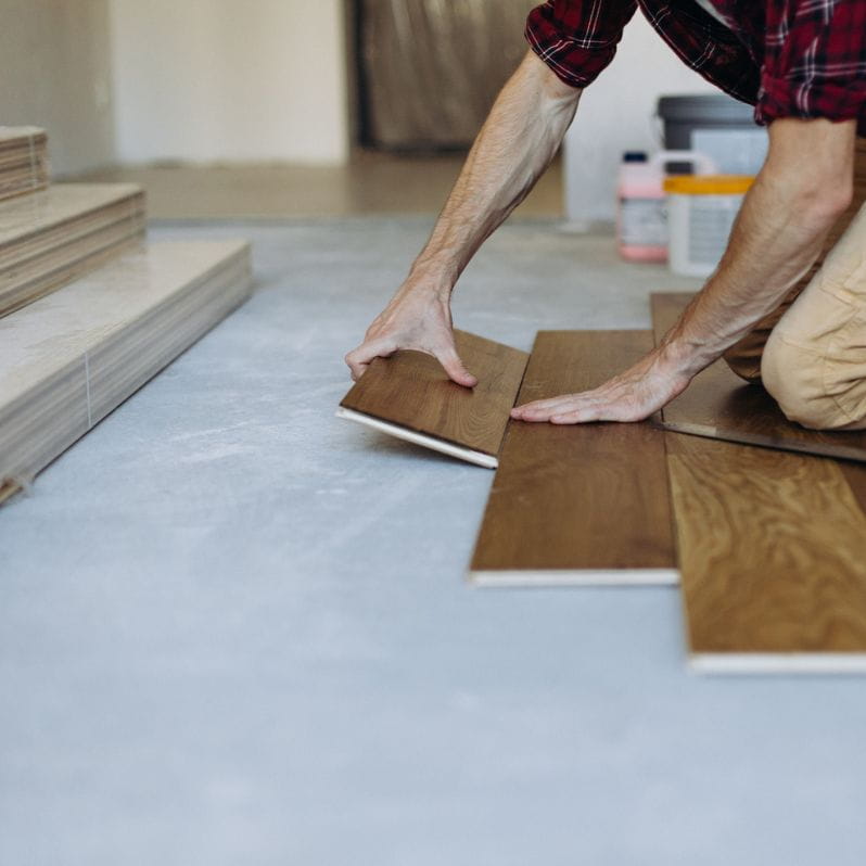 man installing hardwood floors