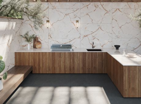 Modern kitchen design featuring marble walls with veining, wooden cabinetry, and minimalistic decor.