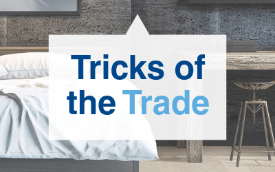Text 'Tricks of the Trade' overlain on a background featuring modern furniture.