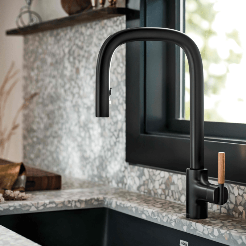 A Moen kitchen faucet in black matte color and finish. 