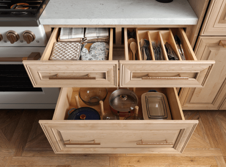 Kitchen drawers organized with utensils, linens, and cooking ware.