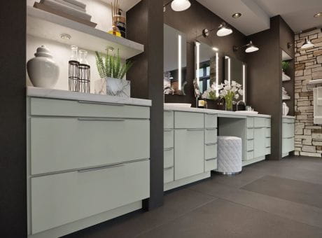 Modern bathroom vanity area with sleek cabinets, illuminated mirrors, and decorative accents.