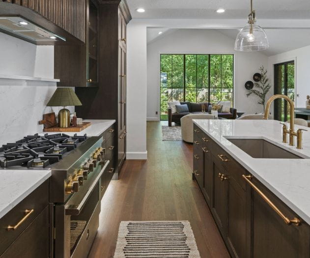 Factory Direct Brunette Hardwood Flooring featured in a modern kitchen and living area highlight the contrast of dark brown wood and white countertops and walls