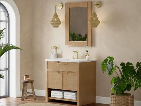 Bathroom interior with wooden vanity, white countertop, mirror, pendant lights, and a potted plant.