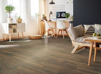 Living room with RevWood Rivercrest flooring, featuring wooden furniture, natural lighting, and a cozy ambiance.