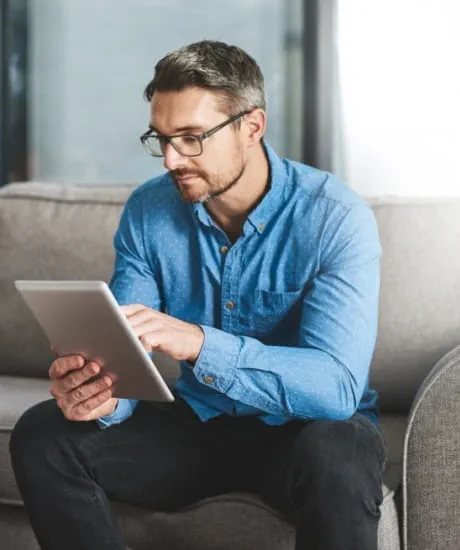 Remodeler reading a tablet about ProSource Wholesale