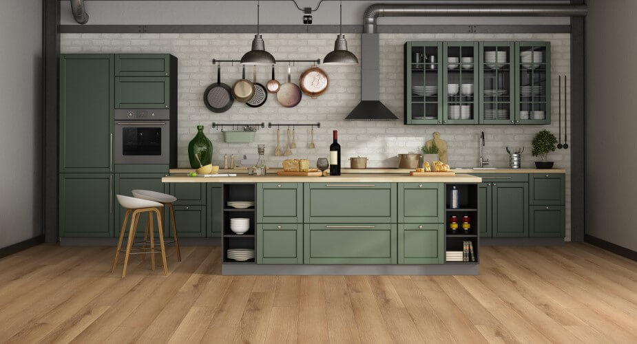 Green cabinets and a island in a kitchen