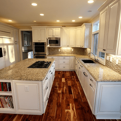 Remodeled kitchen with dark wood floors and white cabinets Louisville KY