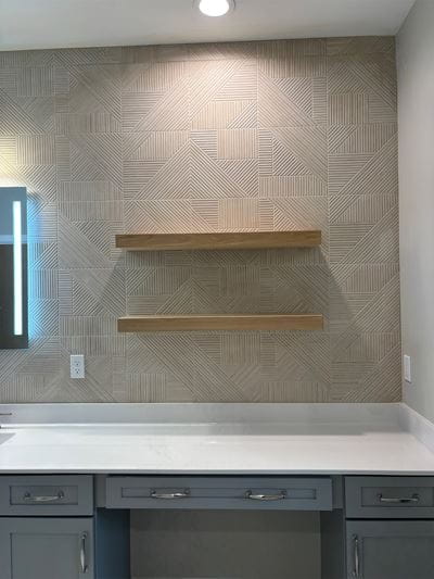 Remodeled bathroom tile backsplash above a vanity
