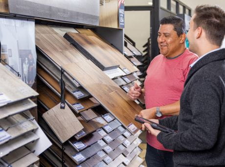 two men looking at flooring samples