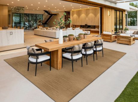 Stylish open-plan dining and living area with elegant furniture and warm lighting.
