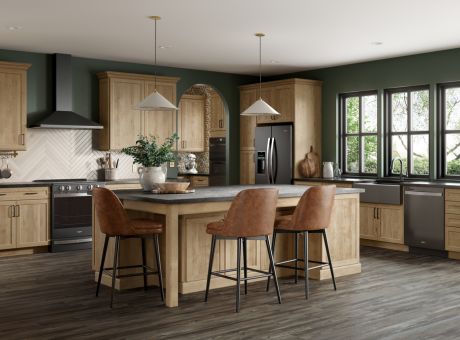 Modern kitchen with island seating, wood cabinets, stainless steel appliances, and large windows.