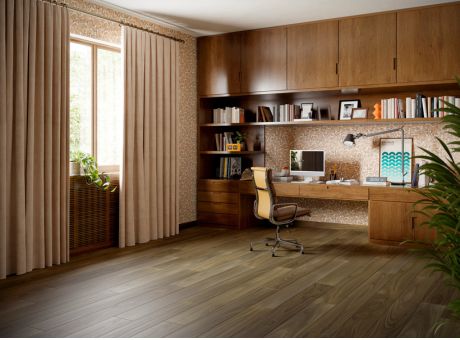 A stylish home office with wooden furniture, a desk setup, bookshelves, and ample natural lighting.