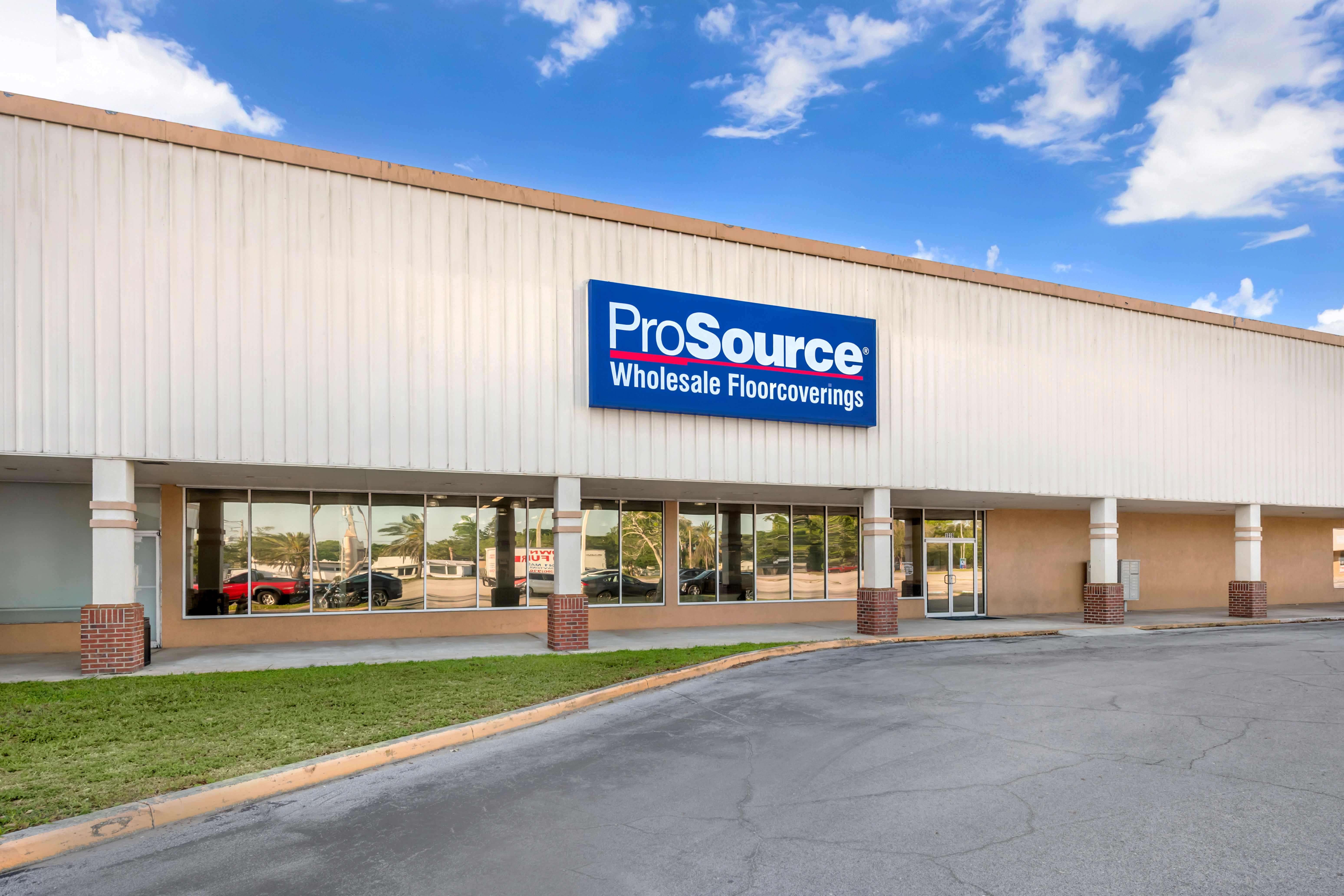 Exterior view of the ProSource Wholesale Floorcoverings store with its building and signage photographed under a slightly cloudy sky.