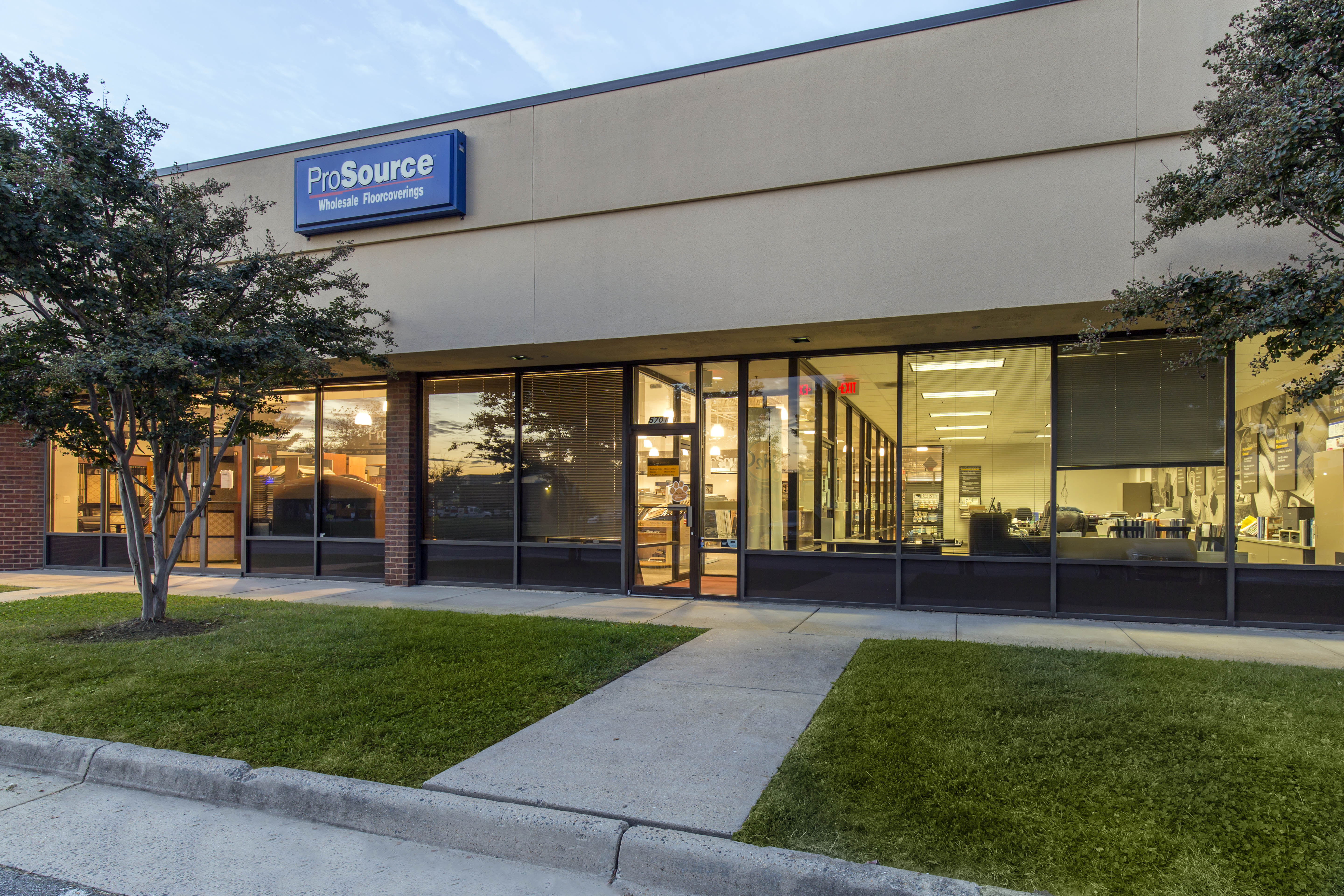 Exterior view of ProSource Wholesale store specializing in flooring materials with clear signage and entrance.
