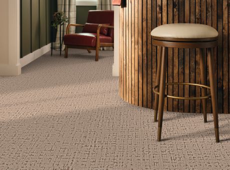 Somerset House carpet in a room with a wooden stool and red armchair.