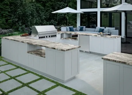 Outdoor kitchen with white cabinets and tiled floor