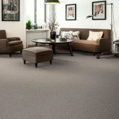 A modern living room with a Duraweave carpet and contemporary furniture including a sofa, armchair, ottoman, and coffee table.