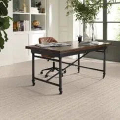 Home office with a wooden desk, chair, and background shelves.