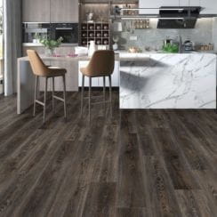 Modern kitchen with white marble island and dark wood flooring.