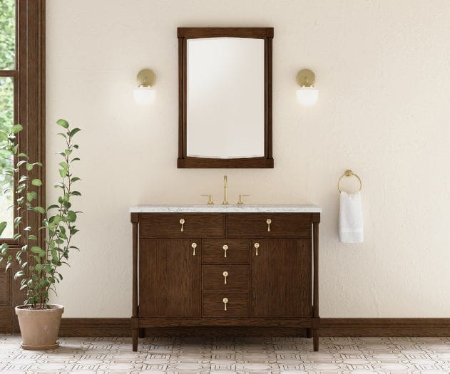Wooden bathroom vanity with a white countertop and attached mirror, flanked by wall-mounted light fixtures.
