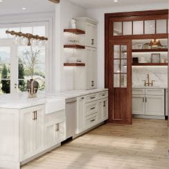 A kitchen featuring light-colored custom cabinets, a farmhouse sink, wooden flooring, and a view of an adjoining area through a windowed door.
