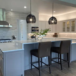 A remodeled kitchen with a tile backsplash