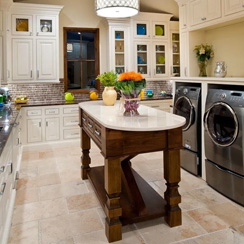 A remodeled laundry room with tile flooring