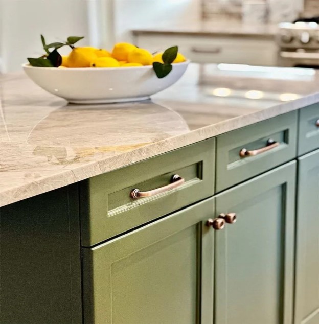 A close-up of bronze cabinet hardward on a kitchen island