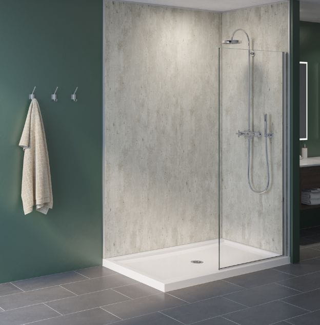 Bathroom with shower corner enclosed by glass, textured wall design, green accent wall, and tiled floor.