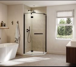 Contemporary bathroom scene with a corner glass shower enclosure, freestanding bathtub, soft lighting, and modern decor.