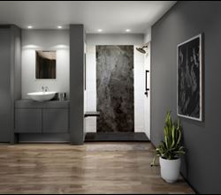 Modern bathroom interior with gray walls, vanity with a white sink, polished stone shower area, and houseplant accent.